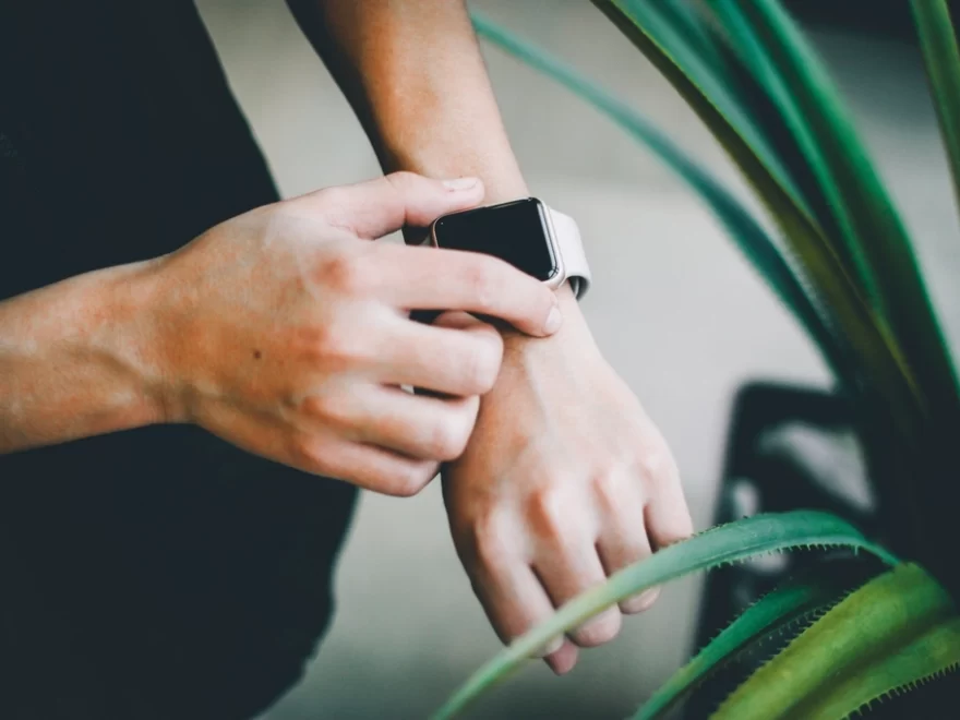Person use silver Apple Watch