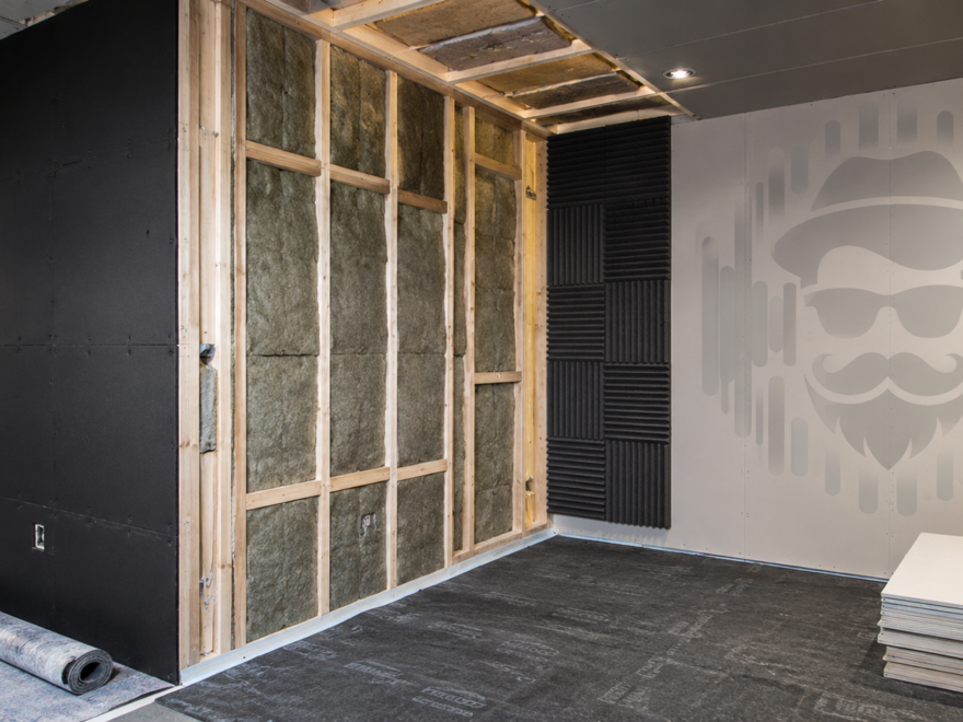Sound isolation room build with insulated stud wall, acoustic panels and drywall sheets
