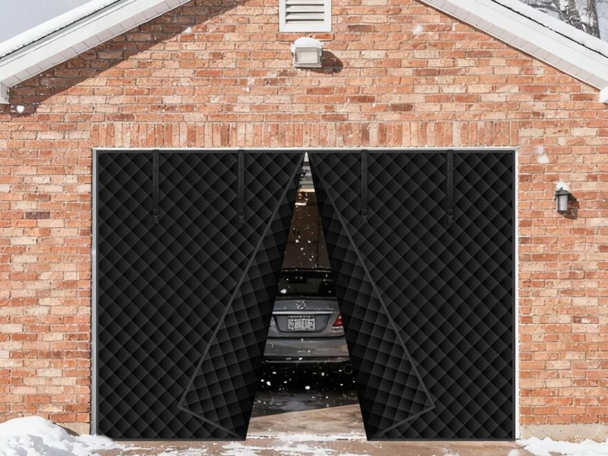 Magnetic thermal insulated garage door curtain for winter, black quilted panels opening on brick garage with car inside and snow outside