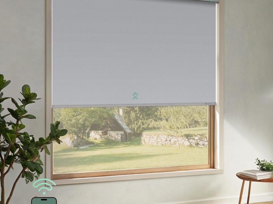 Yoolax Motorized Roller Shades with cordless white roller shade on window, remote control and smart home app shown