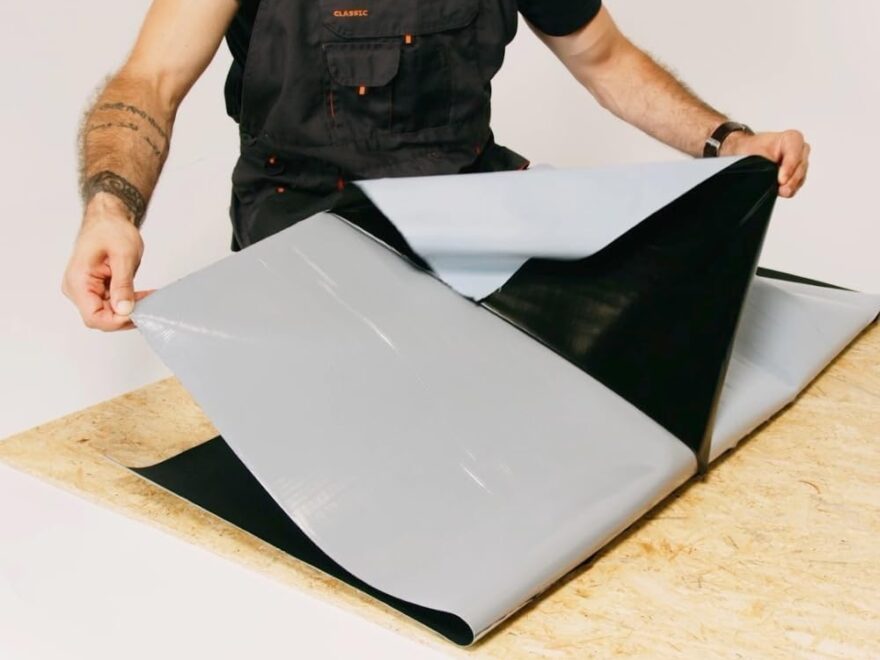 HSS EPDM Waterproofing Membrane EasyStick sheet with black rubber layer and peel-back backing on a worktable