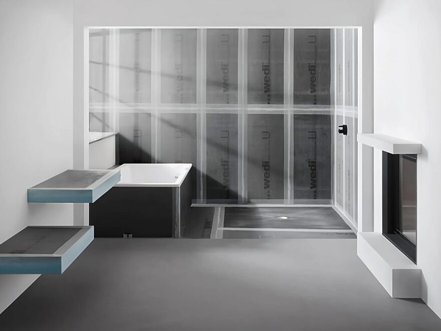 Wedi Waterproofing Building Panel with gray waterproof panels installed around a bathtub and shower wall frame