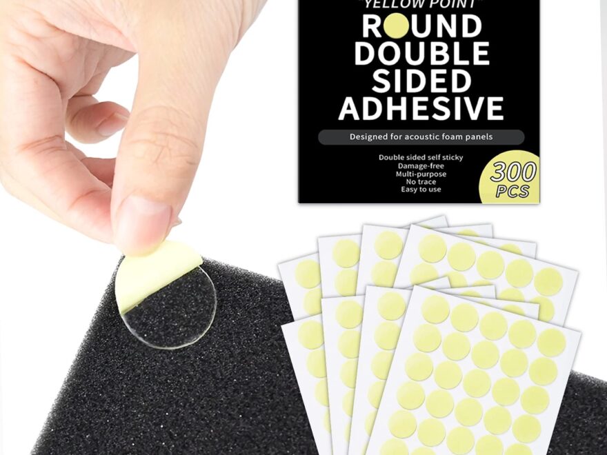 Focusound Yellow Point double-sided adhesive dots on peel-and-stick sheets, shown being applied to a black textured acoustic foam panel
