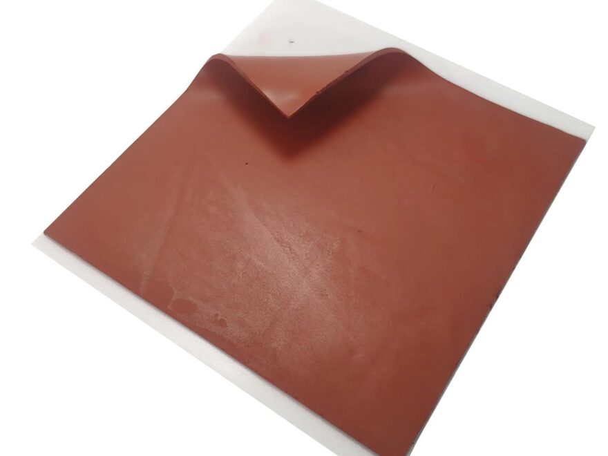 Acoustic Outlet Soundproofing Putty Pads 7 x7 sheet with reddish brown textured surface and white peel-away backing