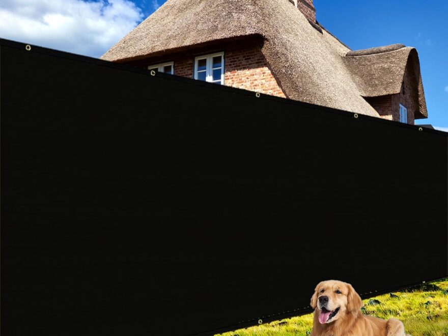 Shade&Beyond 4 X 50 black fence privacy screen with grommets installed in a yard behind a dog