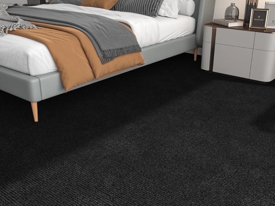 FunStick 12x12 peel and stick carpet tiles with black textured surface installed as bedroom flooring